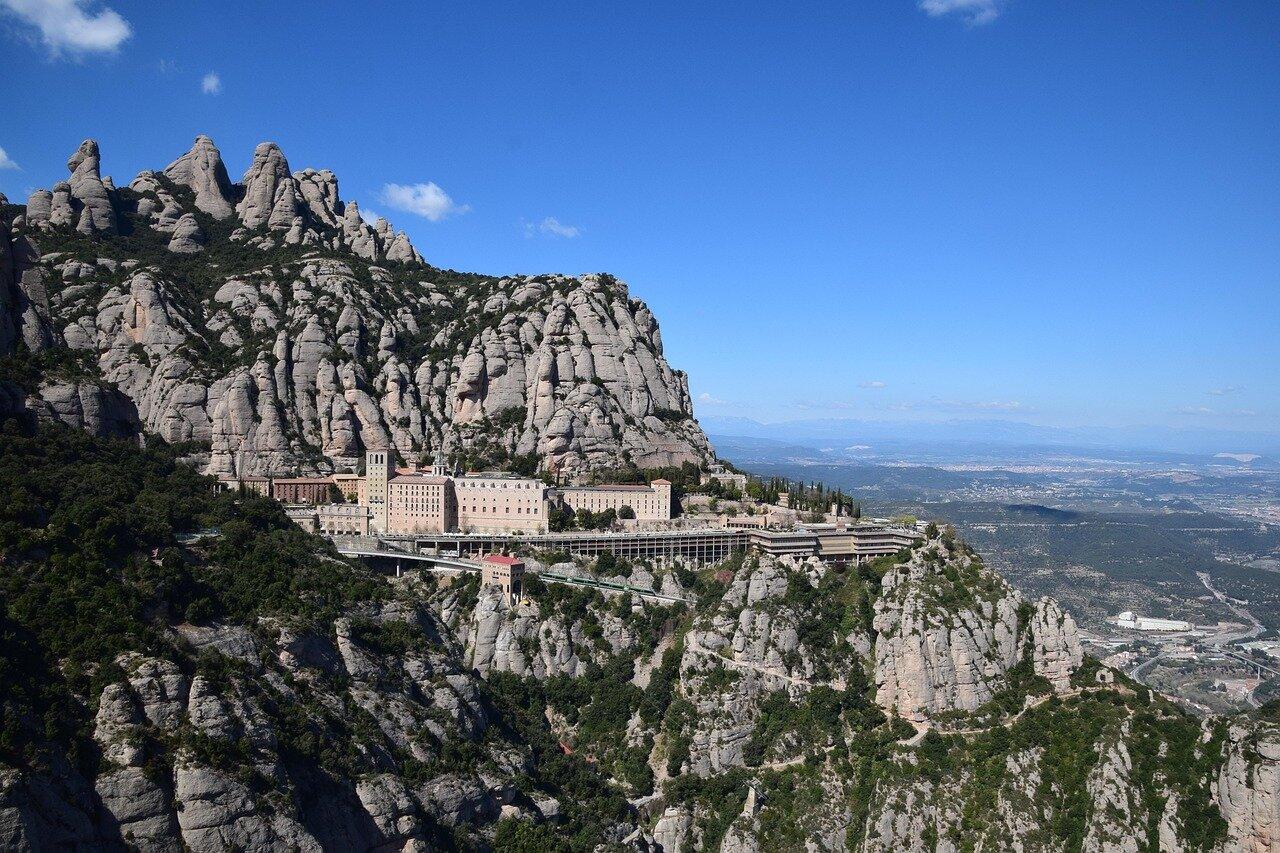 Forested mountain slopes above a compact stone village