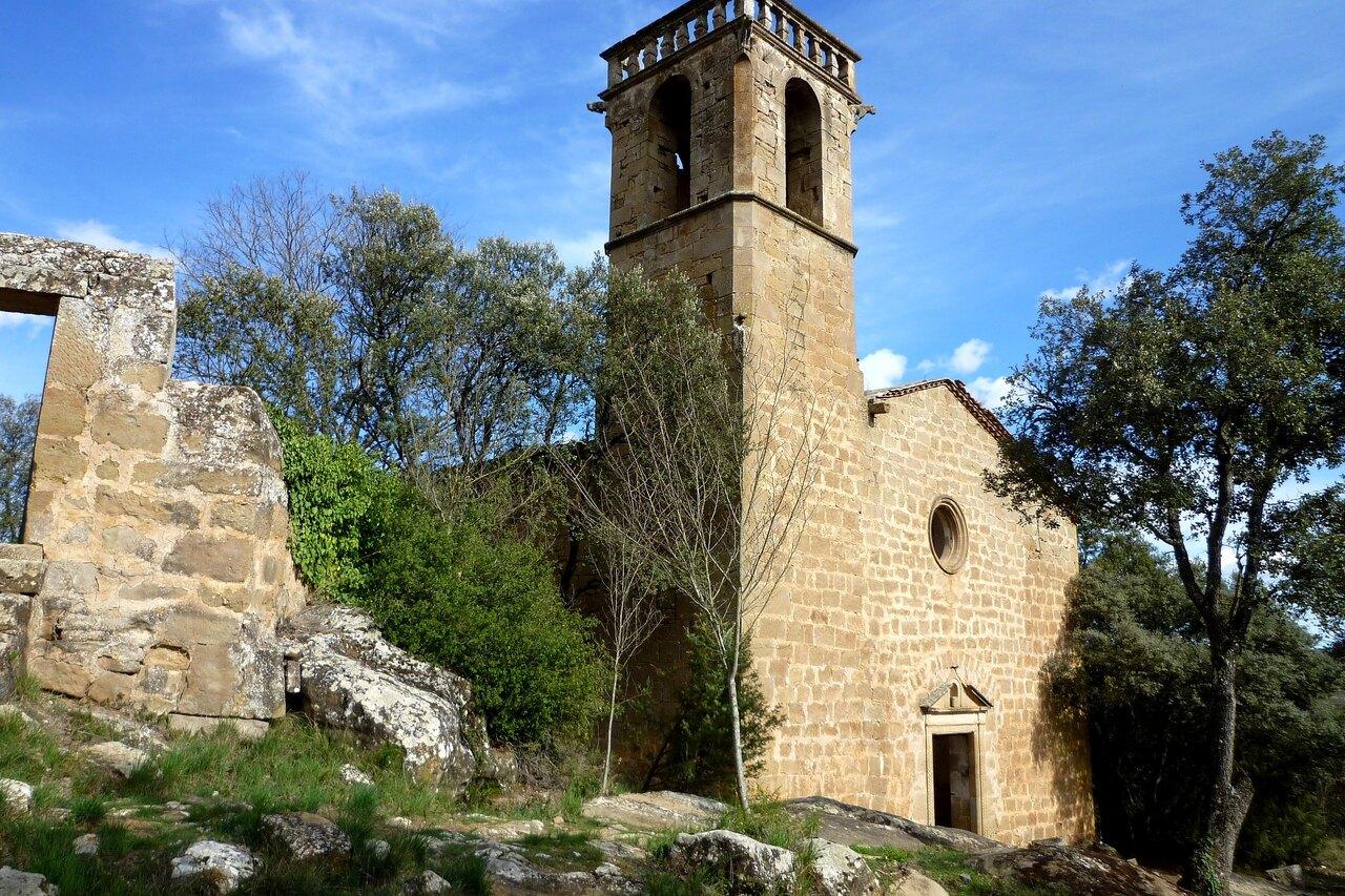 Sant Pere de Vallferosa church beside rocky and wooded ground